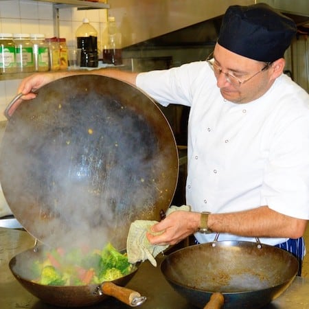 Hospitality worker preparing food during practical training