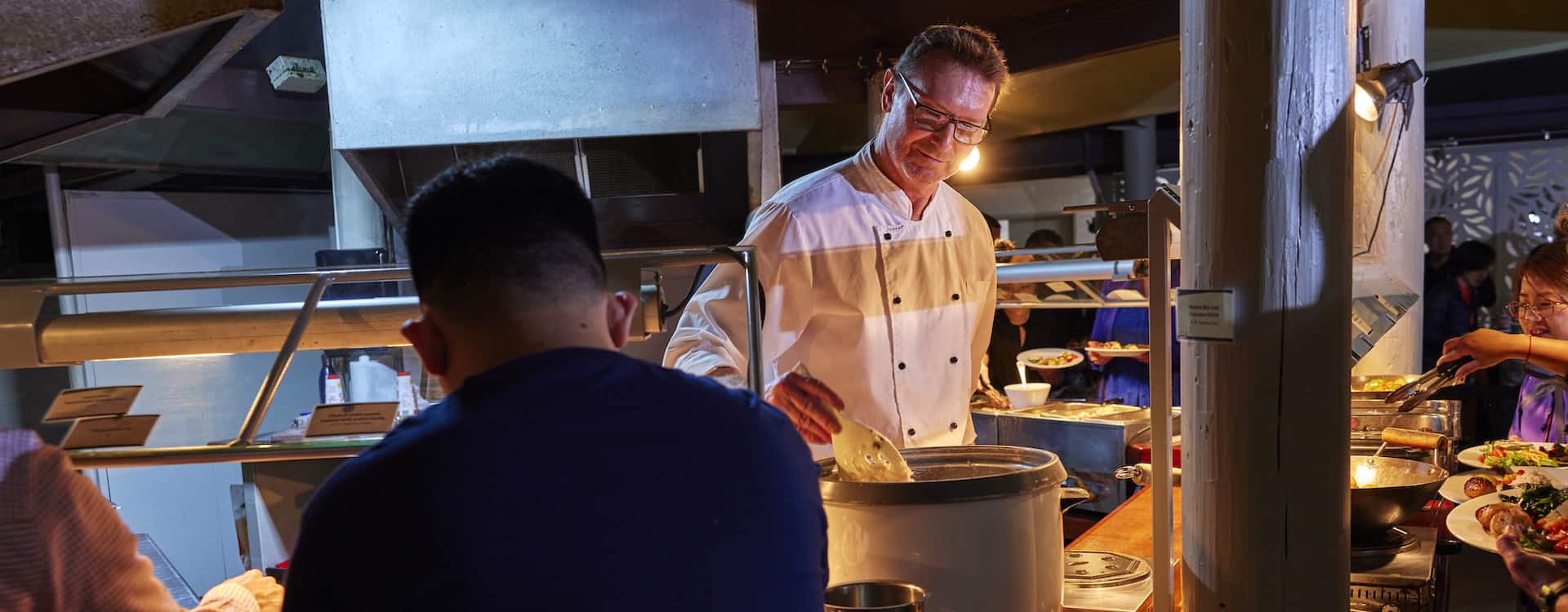 Hospitality worker preparing buffet service
