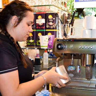 Hospitality student learning to make coffee